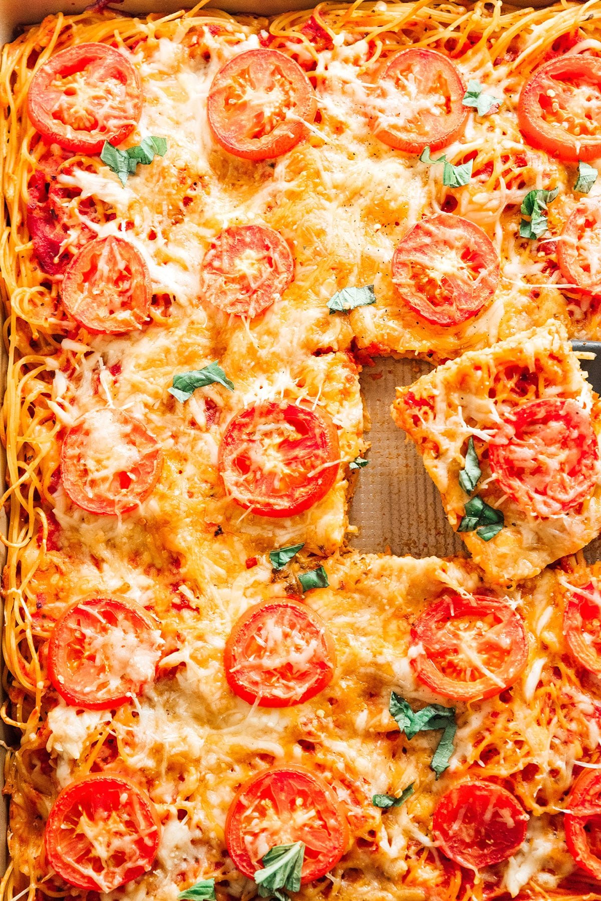 Baked Spaghetti Pizza in a tray, but into squares.