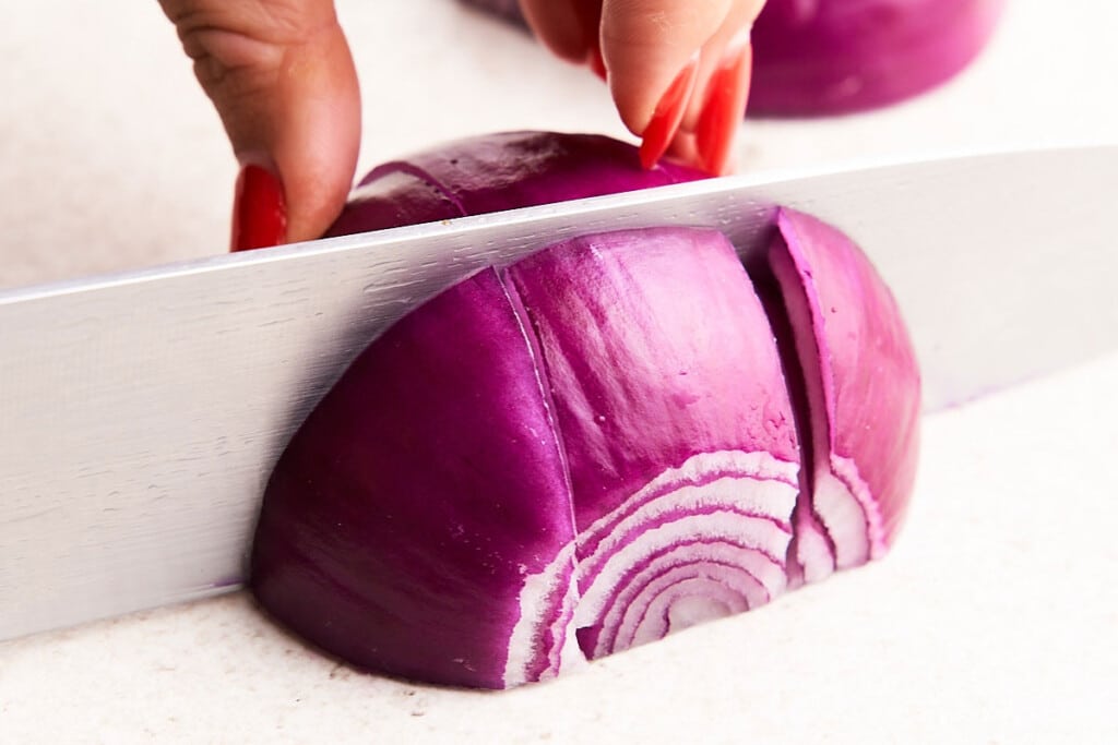 Cutting onion into chunks.