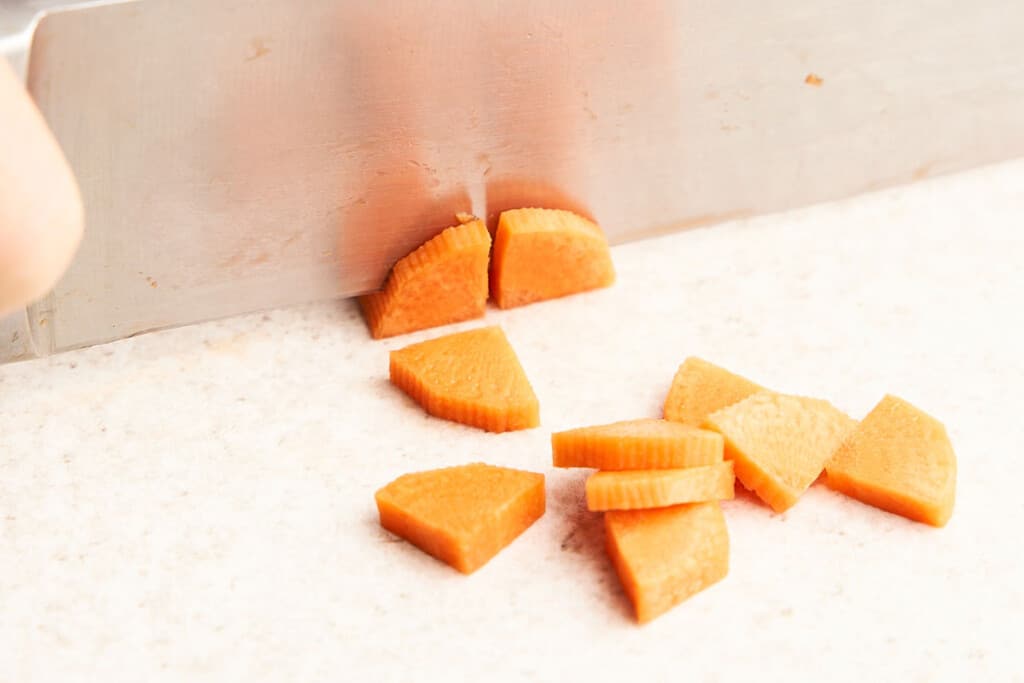 Cutting carrots into dices.