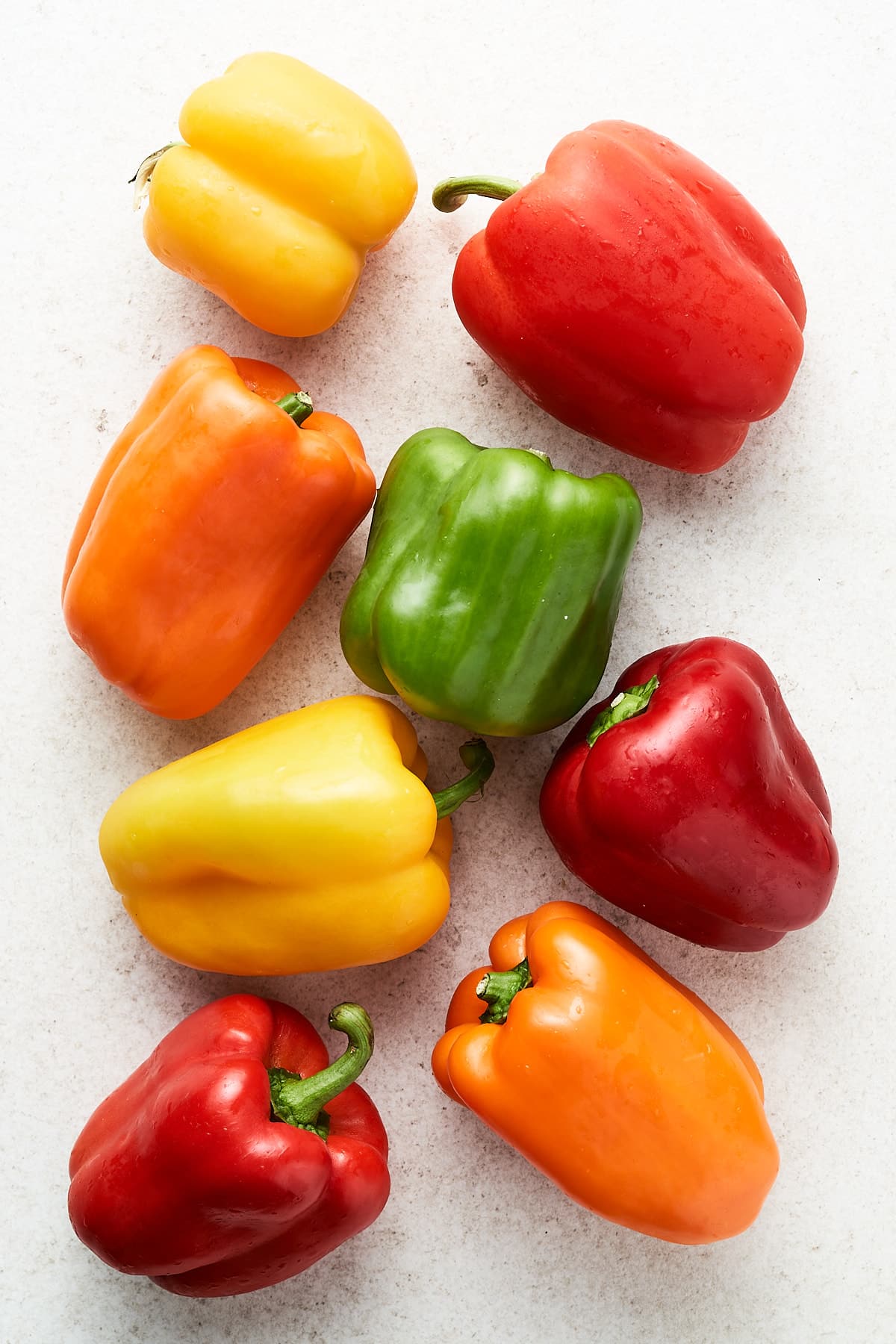 Red, green, yellow, and orange bell peppers.
