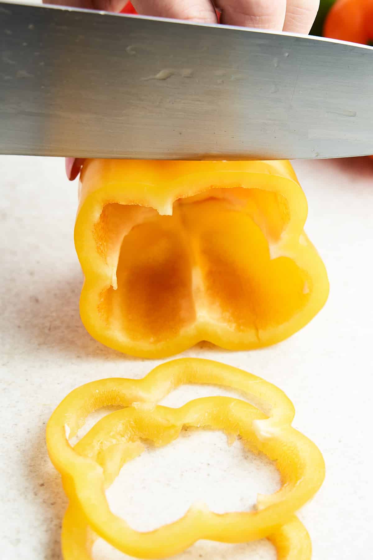 Slicing a bell pepper into rings.
