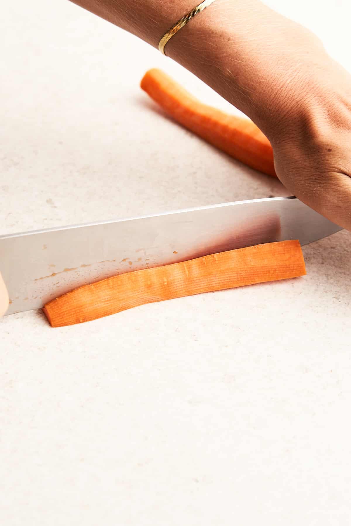 Cutting a carrot into quarters.