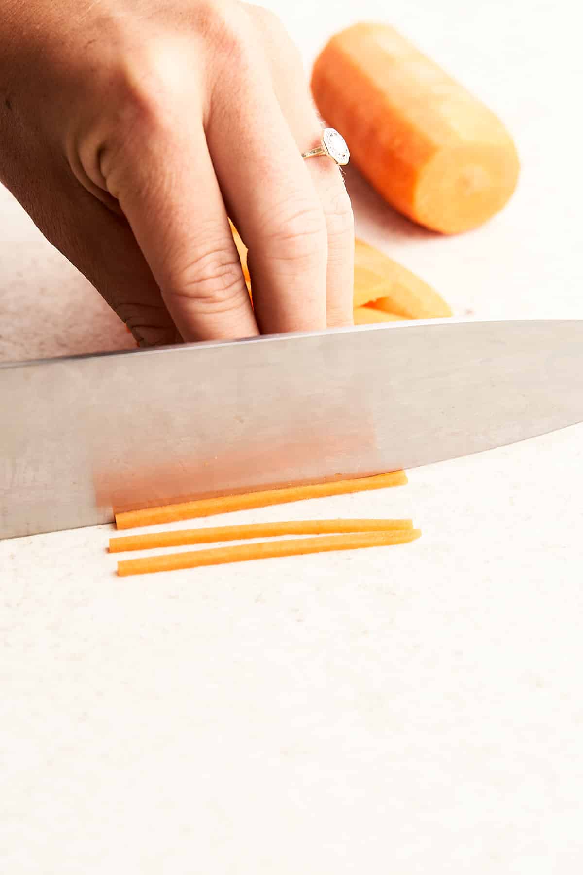 Cutting a carrot into matchsticks.