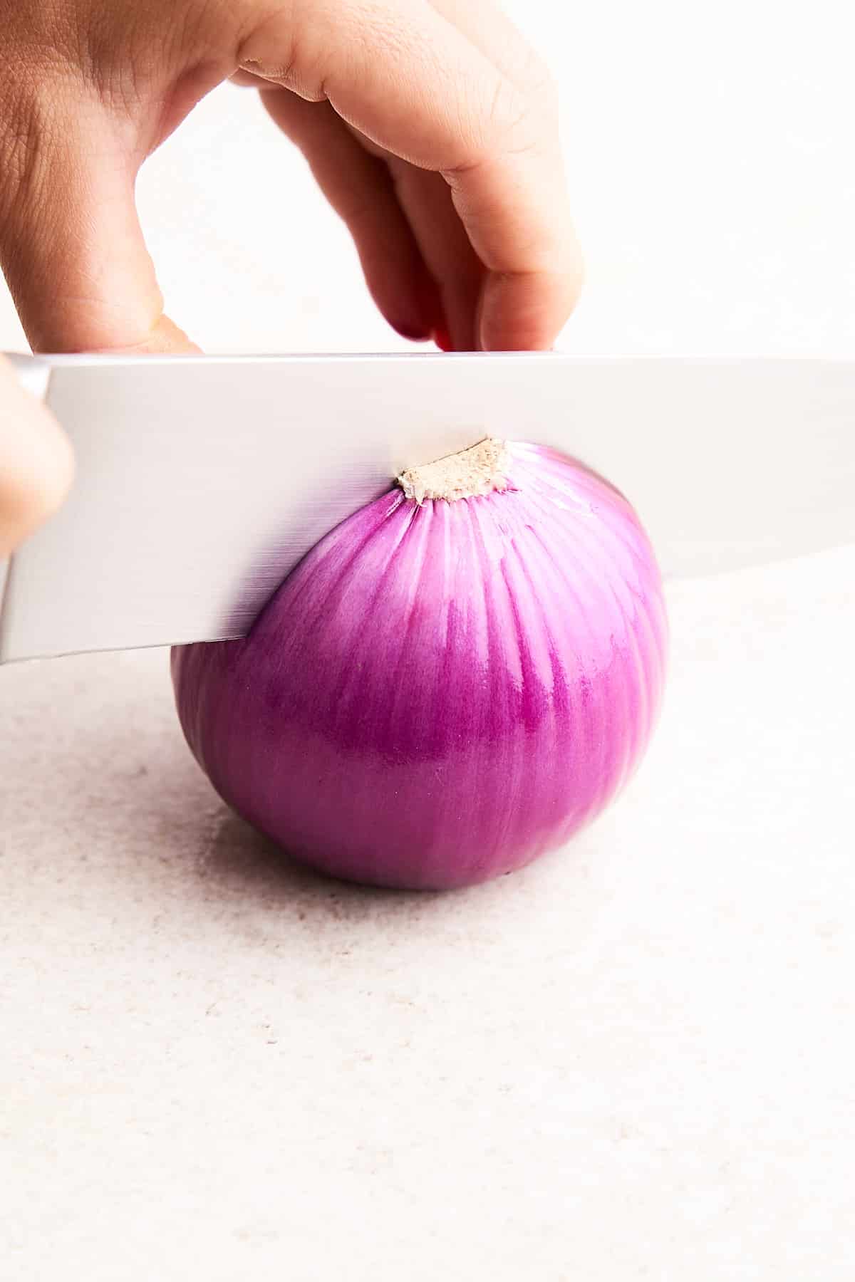 Cutting an onion in half.