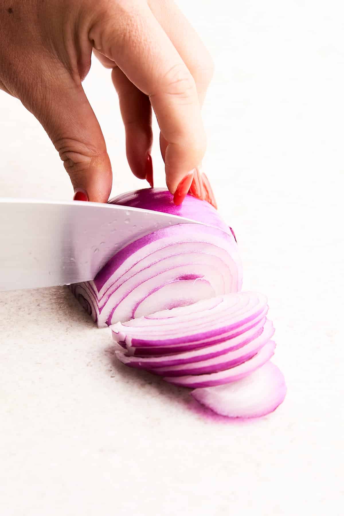 Slicing an onion lengthwise.
