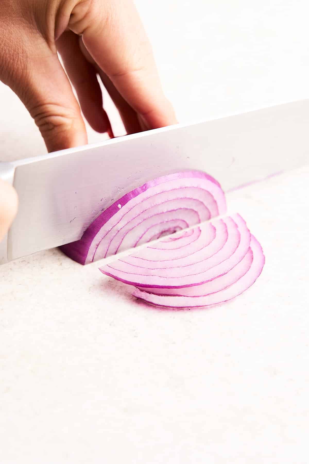Slicing an onion crosswise.