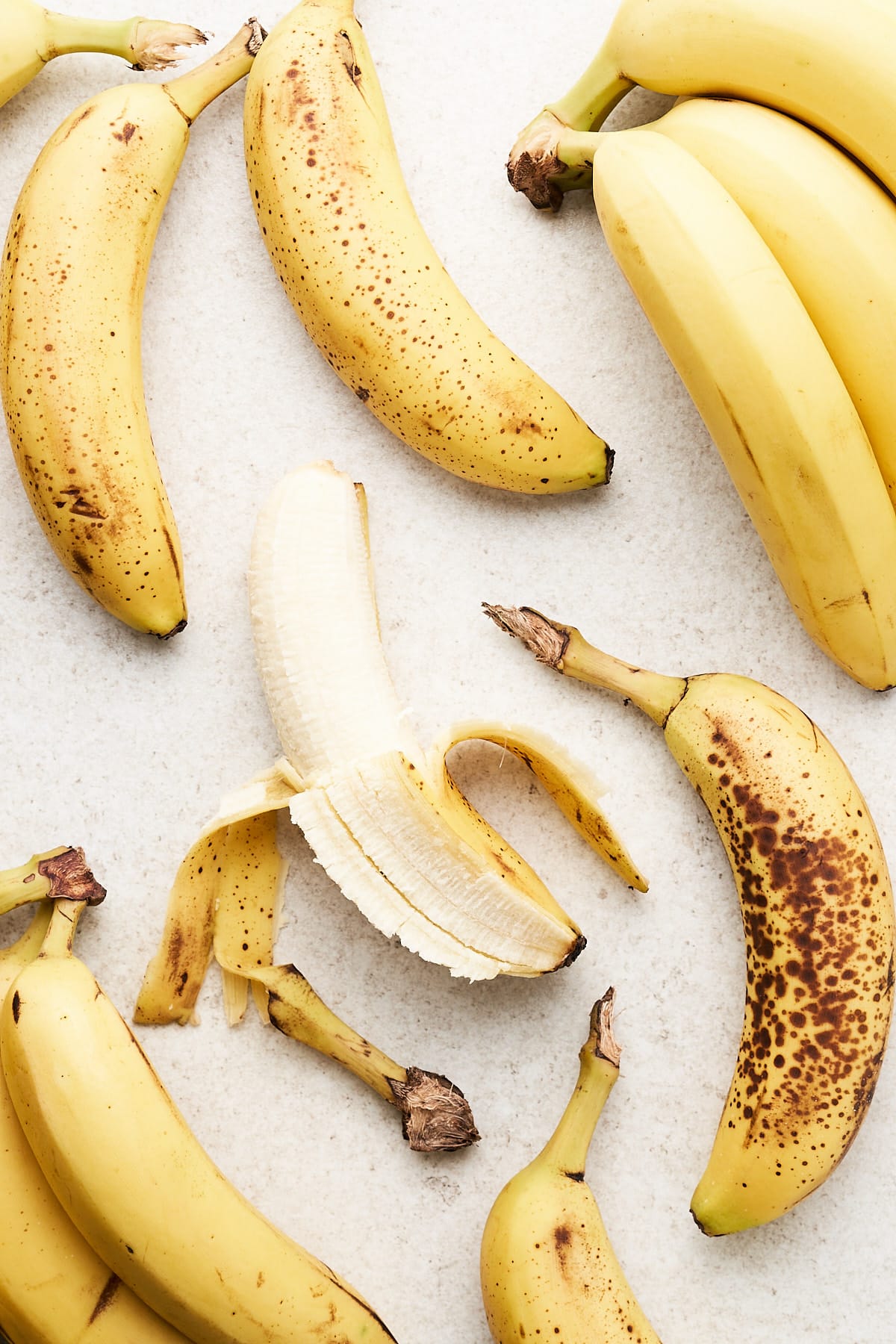 Peeled bananas on a counter.