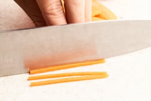 Cutting carrots in julliene.