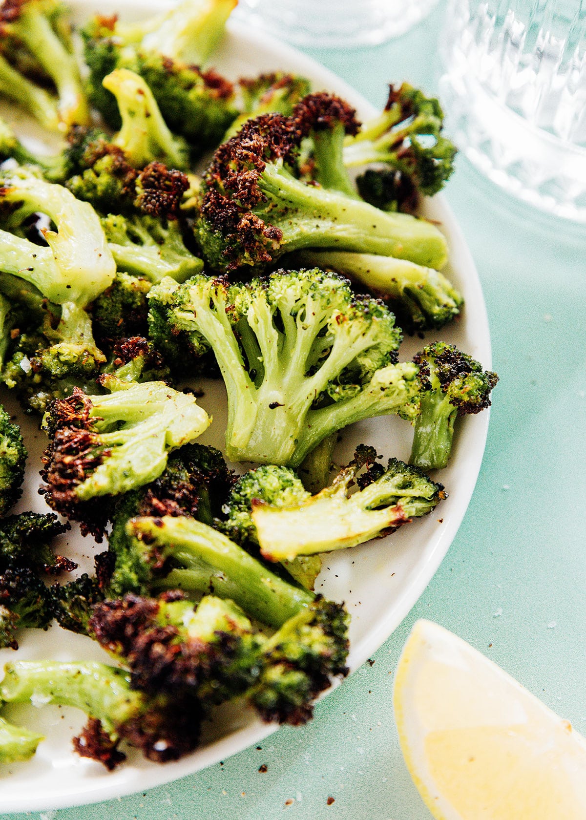 Brown and crispy broccoli florets in a white serving bowl.