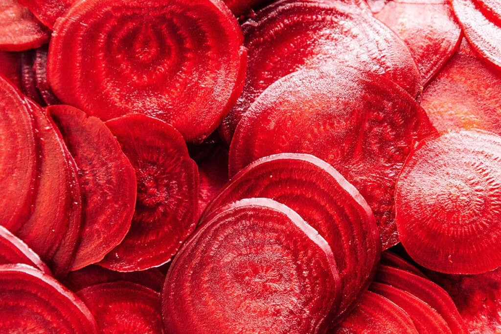Cut Beets: Allow beets to cool slightly, then peel each. Using a mandolin slicer (or carefully with a chef's knife), thinly slice each beet.