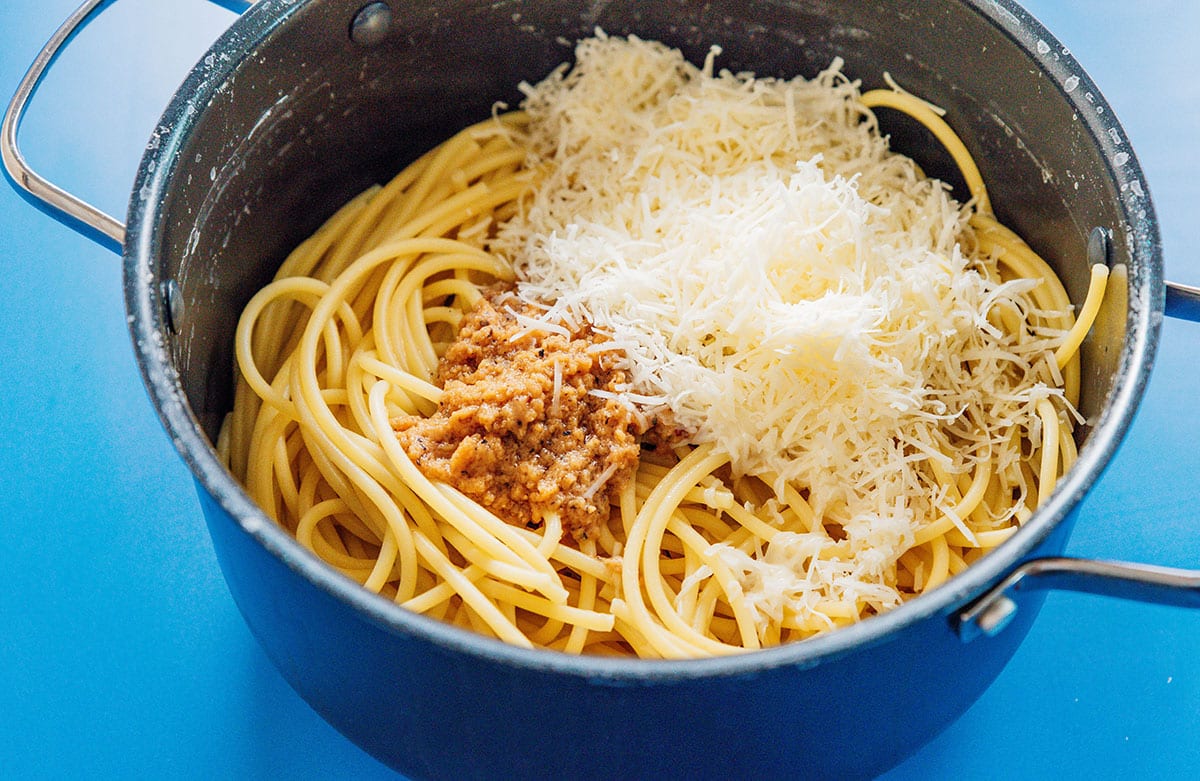 Pan of pasta with miso sauce and parmesan.