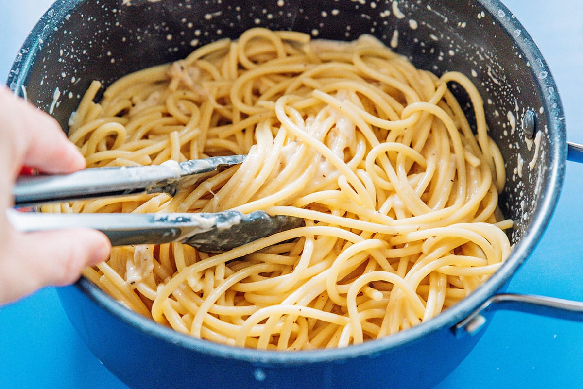 Miso pasta being tossed together in a sauce pan.