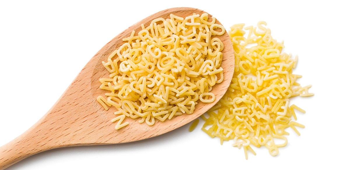 Alphabet pasta on a white background. 