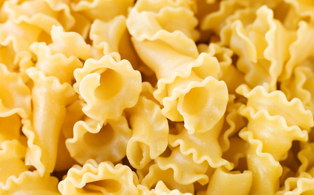 Campanelle pasta on a white background. 