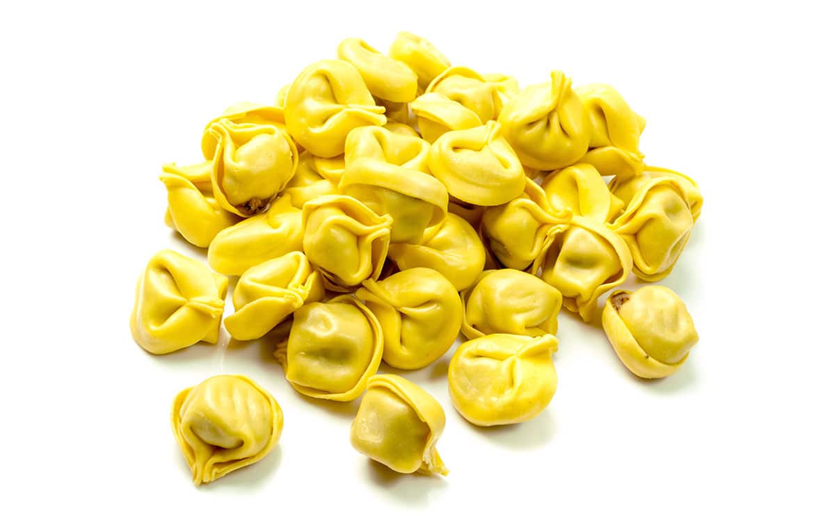 Cappalletti pasta on a white background. 
