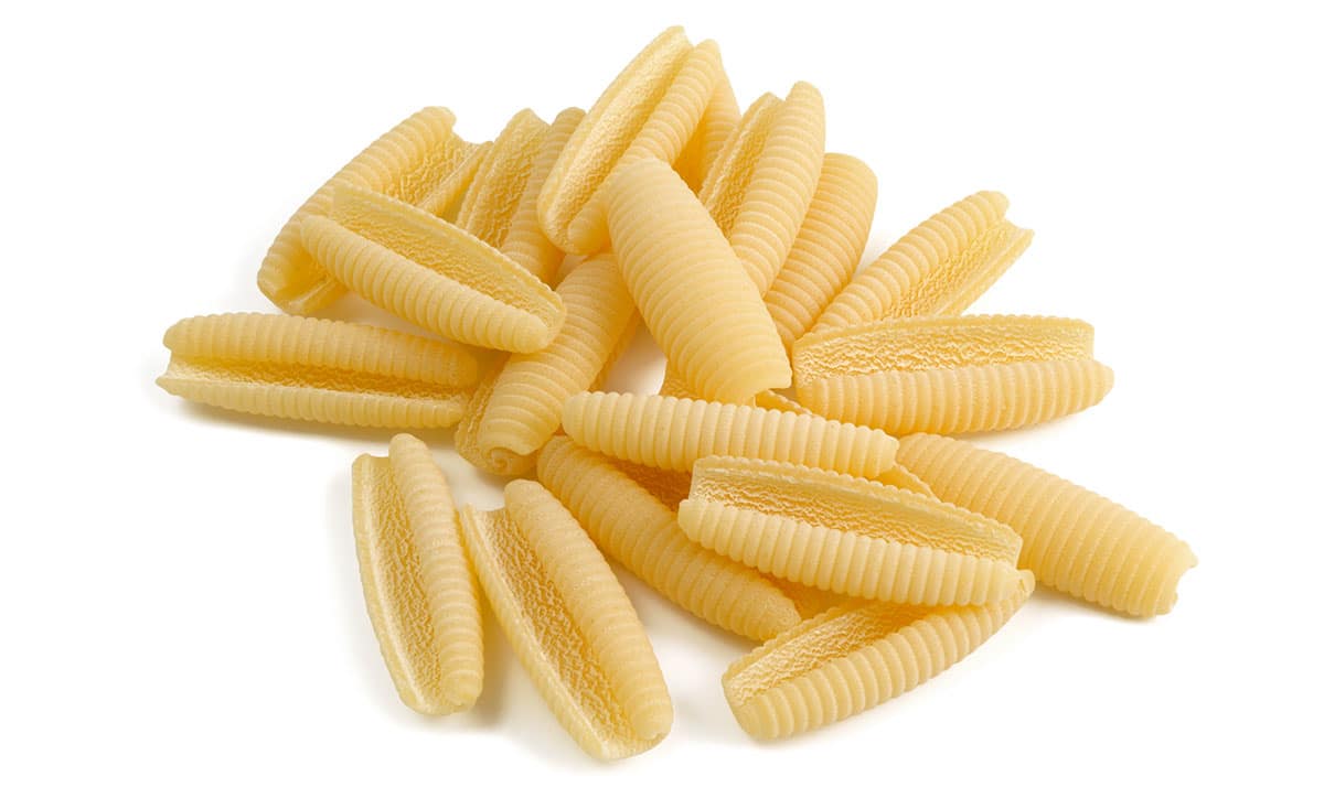 Cavatelli pasta on a white background. 