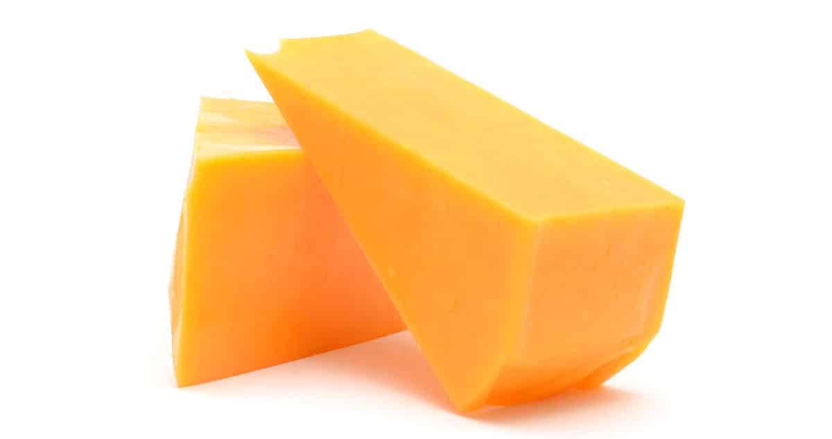 Cheddar cheese isolated on a white background.