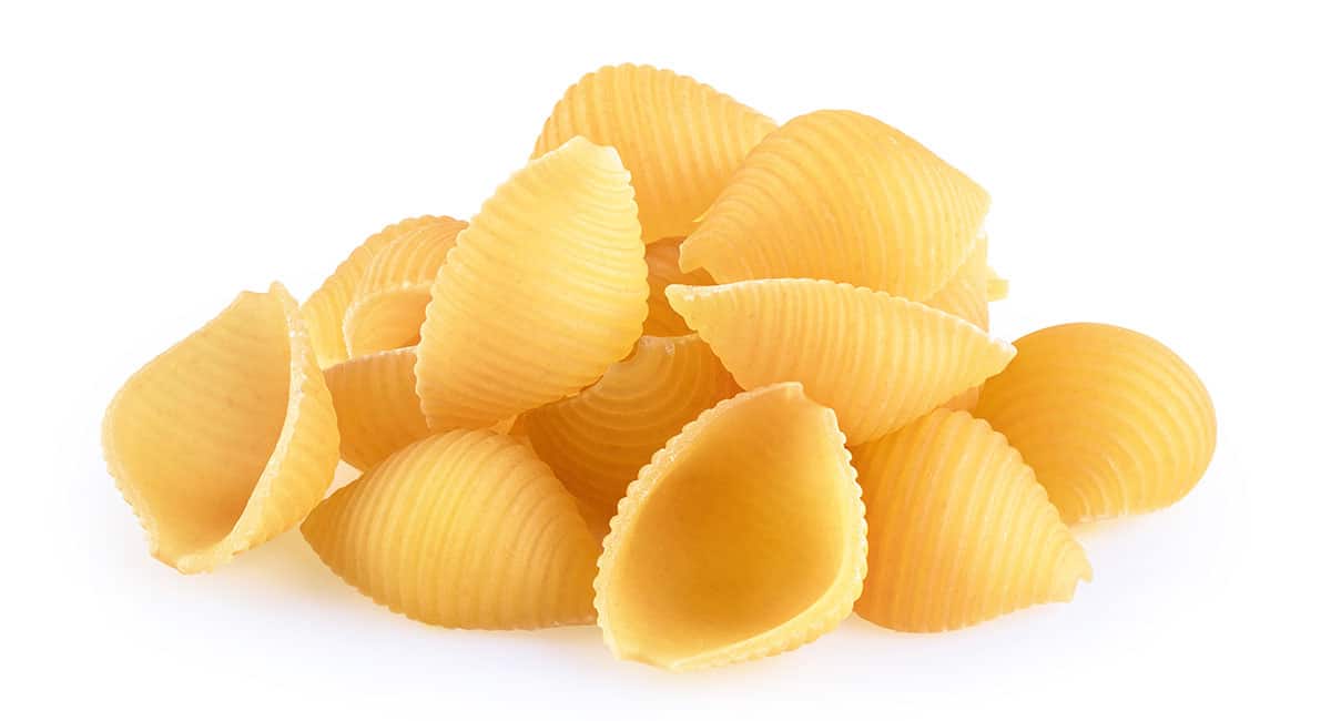 Conchiglie pasta on a white background. 