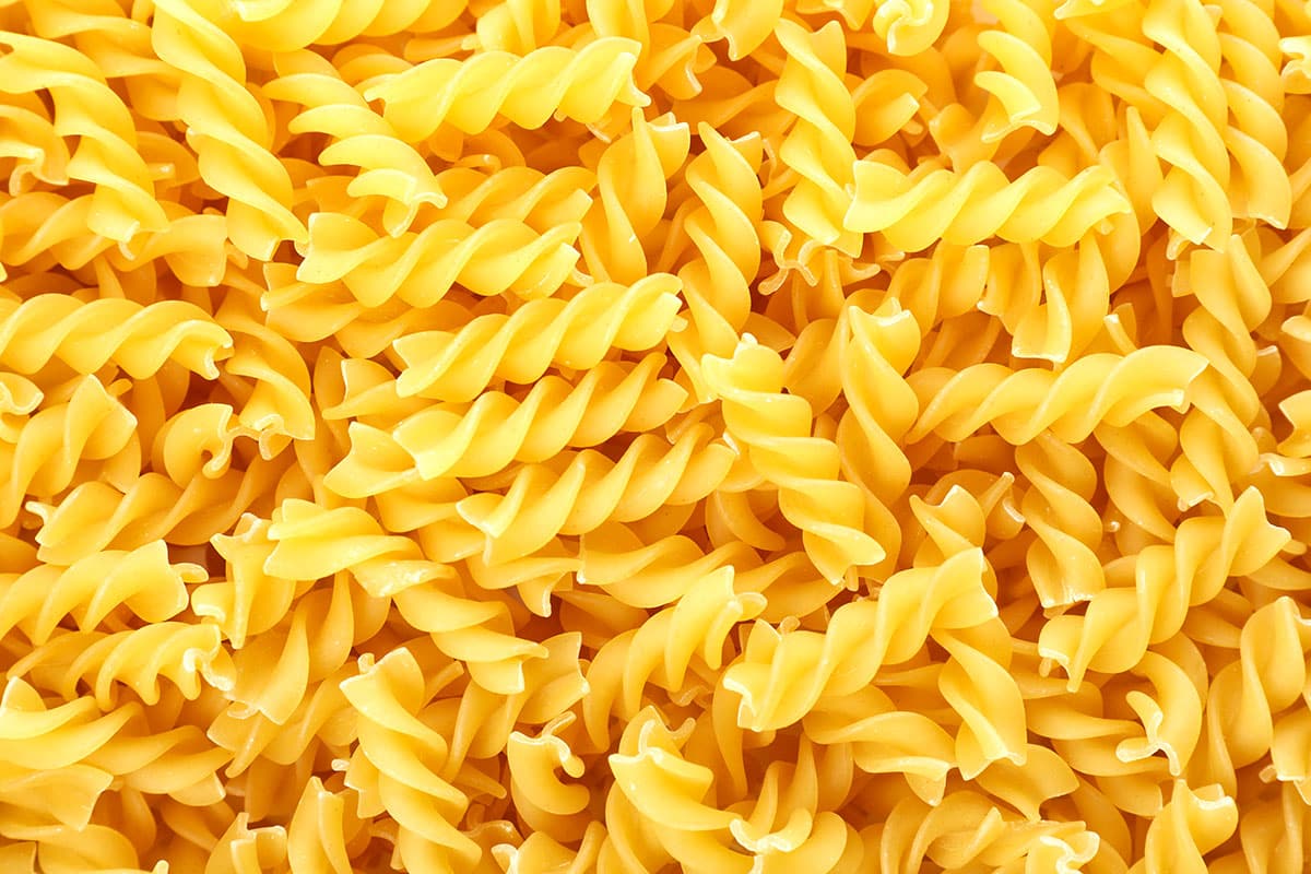 Fusilli pasta on a white background. 