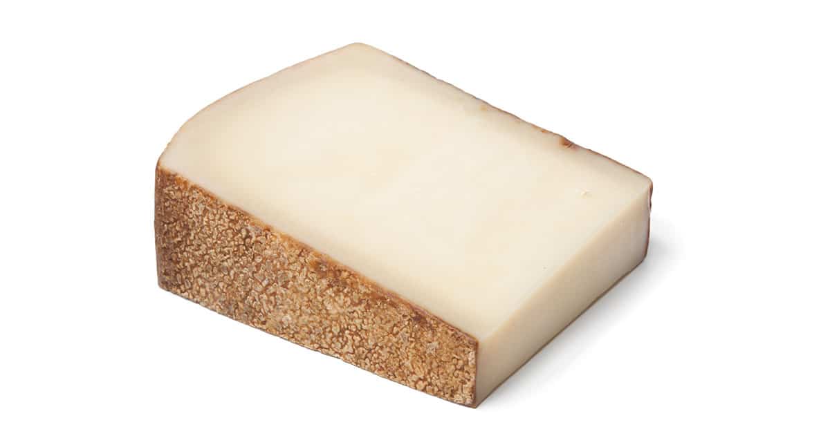 Gruyere cheese isolated on a white background.