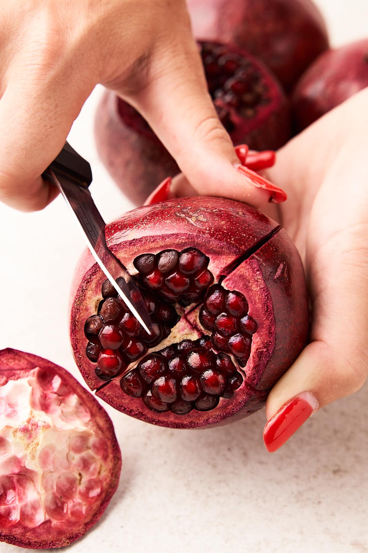 Cutting a pomegranate into sections.