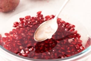 Skimming membrane out of pomegranate with water.