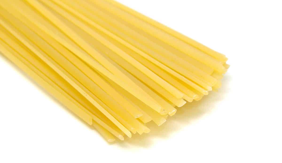 Linguine pasta on a white background. 
