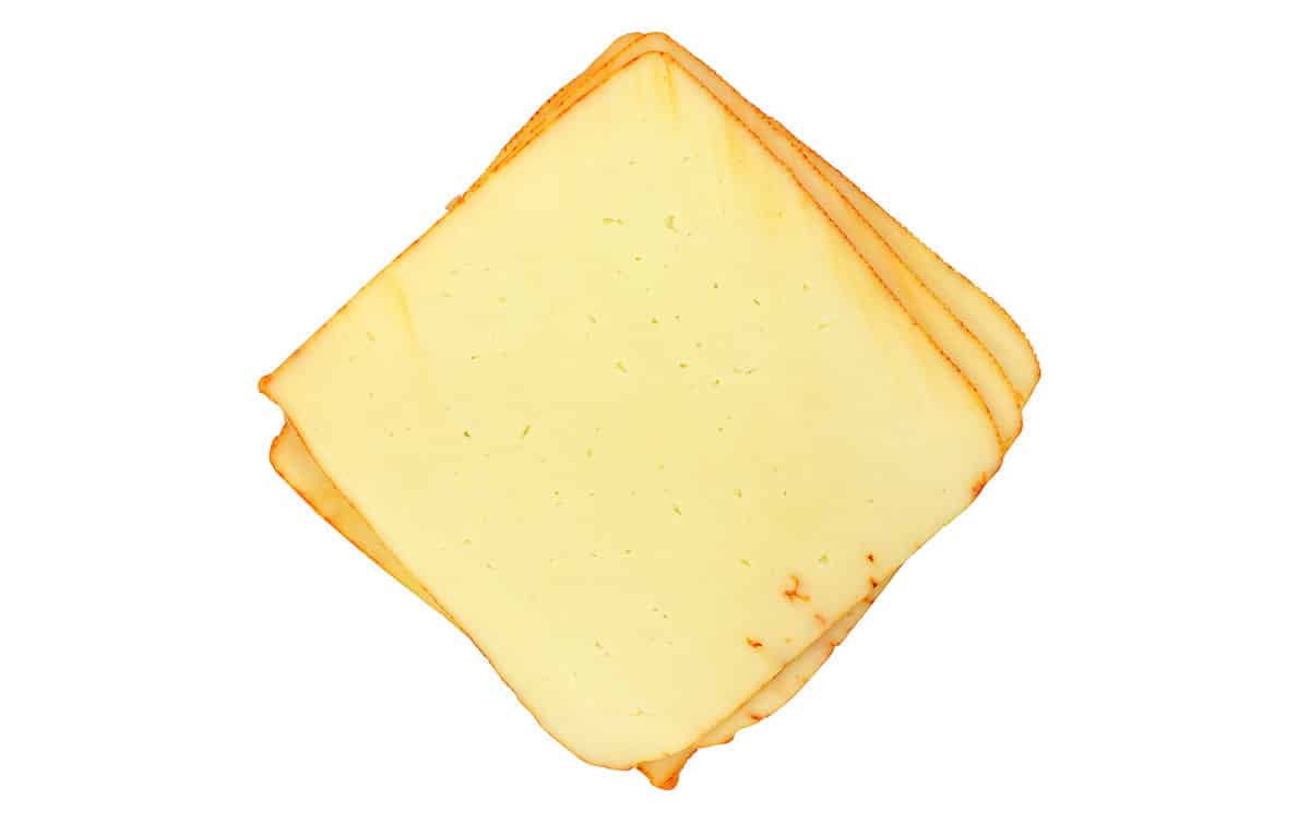 Muenster cheese isolated on a white background.