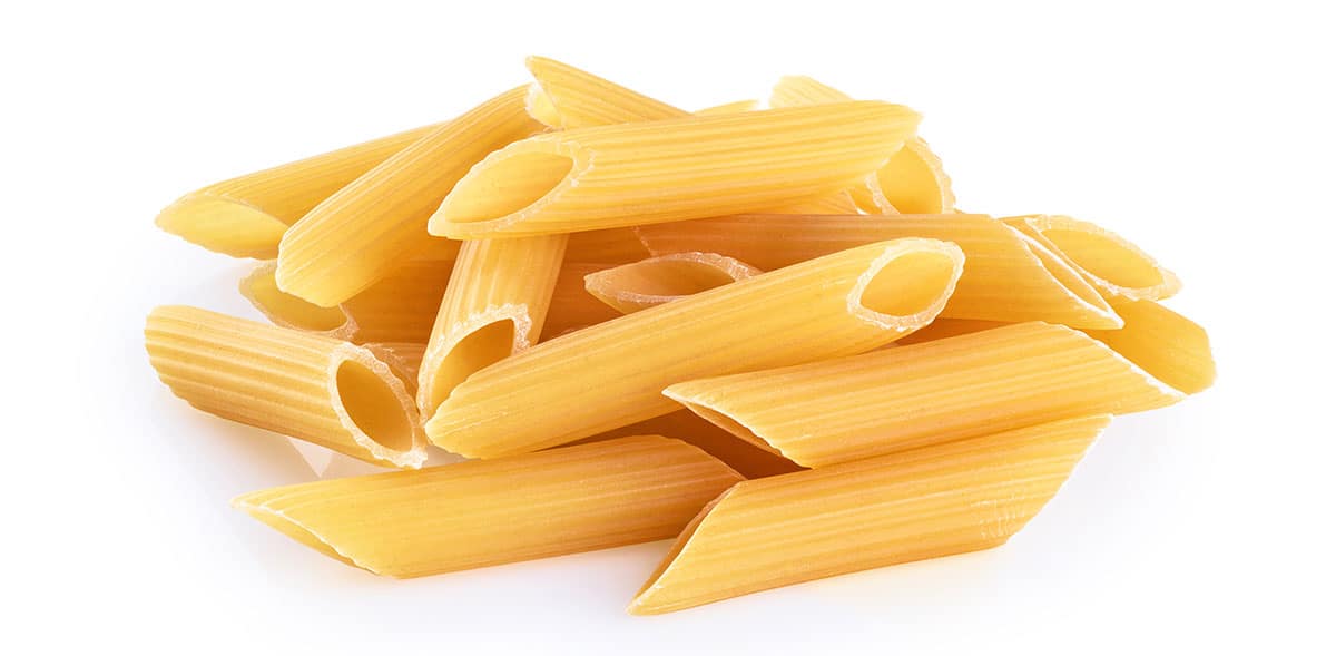 Penne pasta on a white background. 