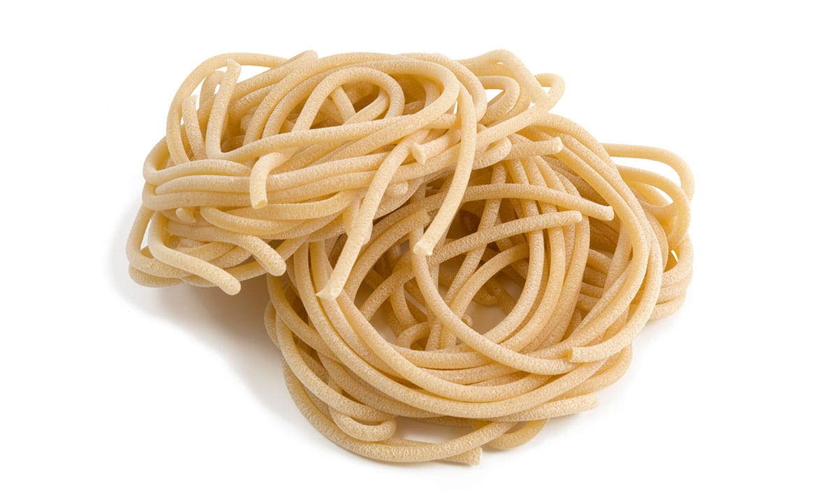 Pici pasta on a white background. 