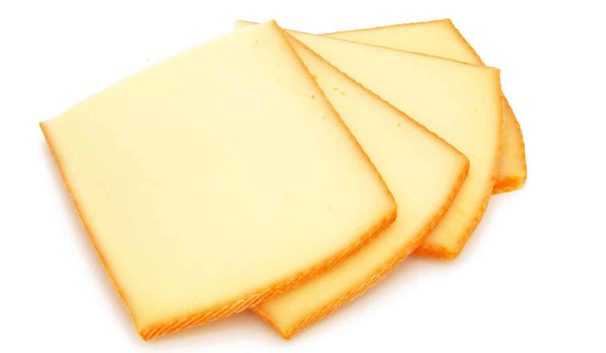 Raclette cheese isolated on a white background.