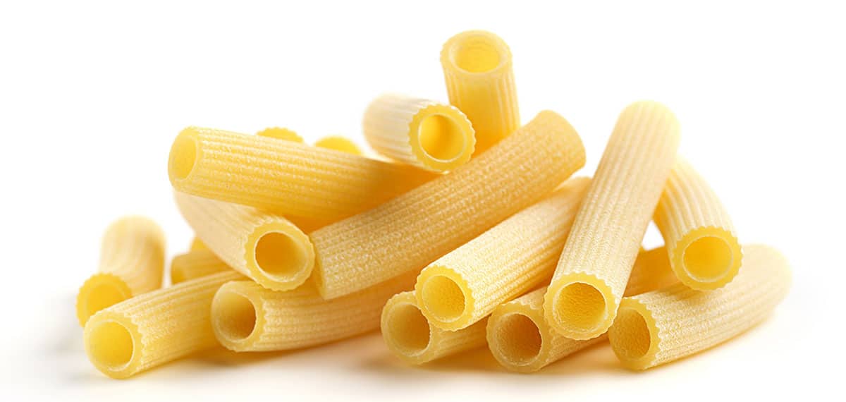Rigatoni pasta on a white background. 