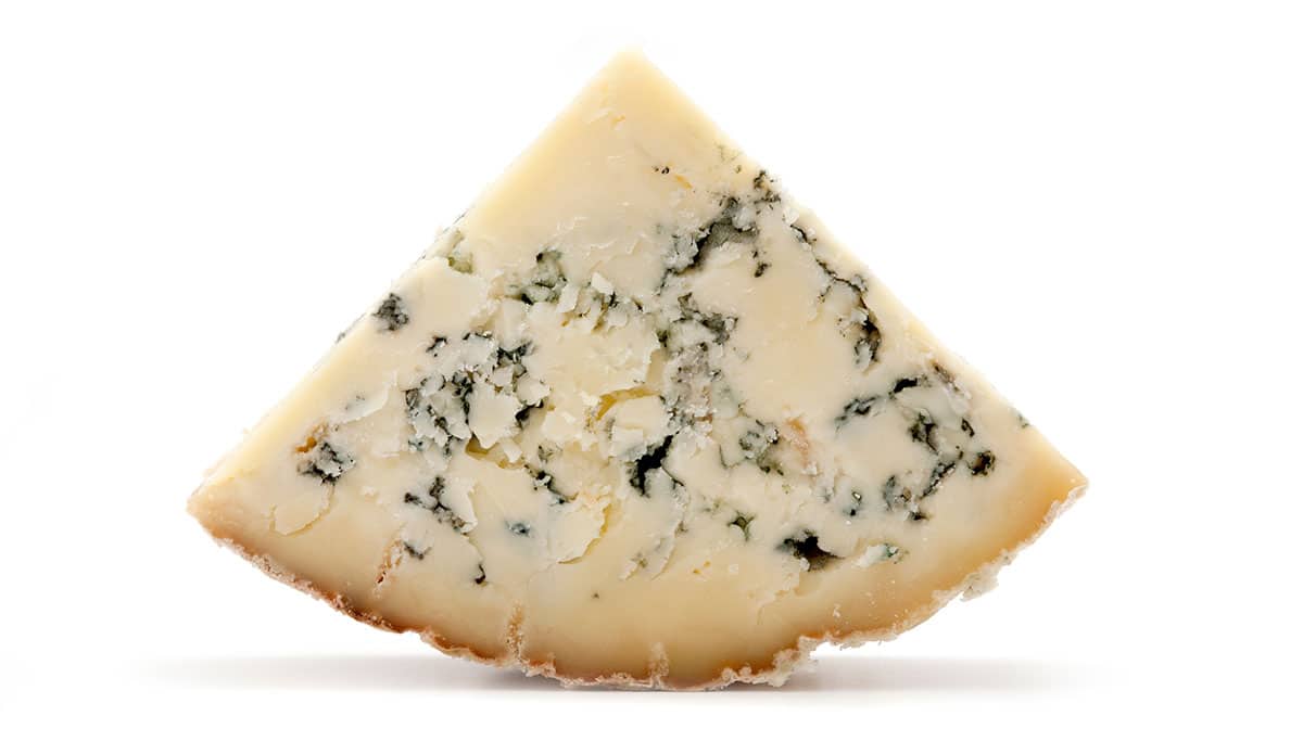 Stilton cheese isolated on a white background.
