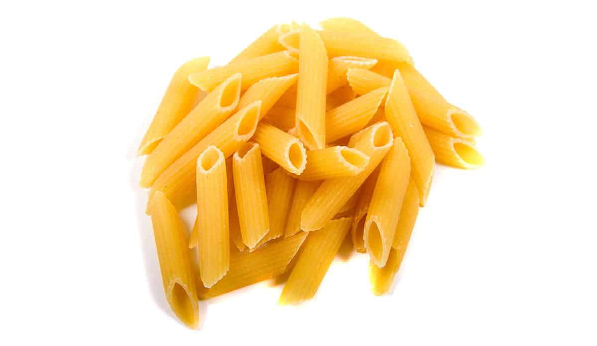 Ziti pasta on a white background. 