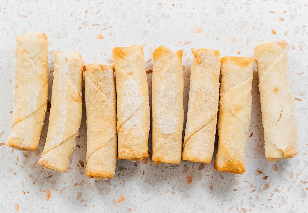 Frozen spring rolls lined up.