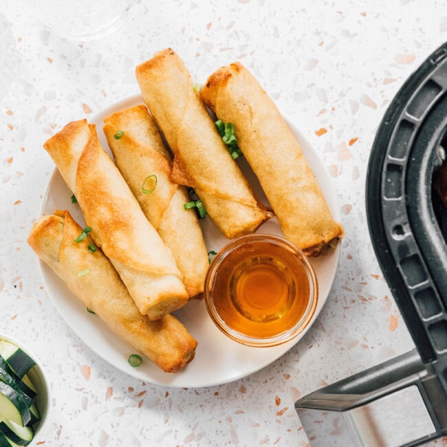 Air fryer spring rolls on a counter.