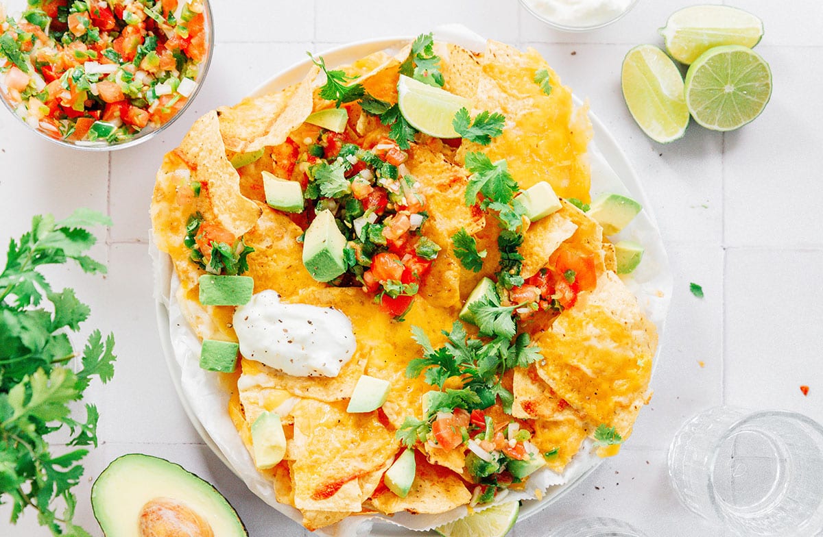 A white platter filled with vegetarian nachos.