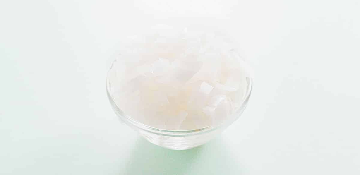 Diced white onion in a glass bowl.