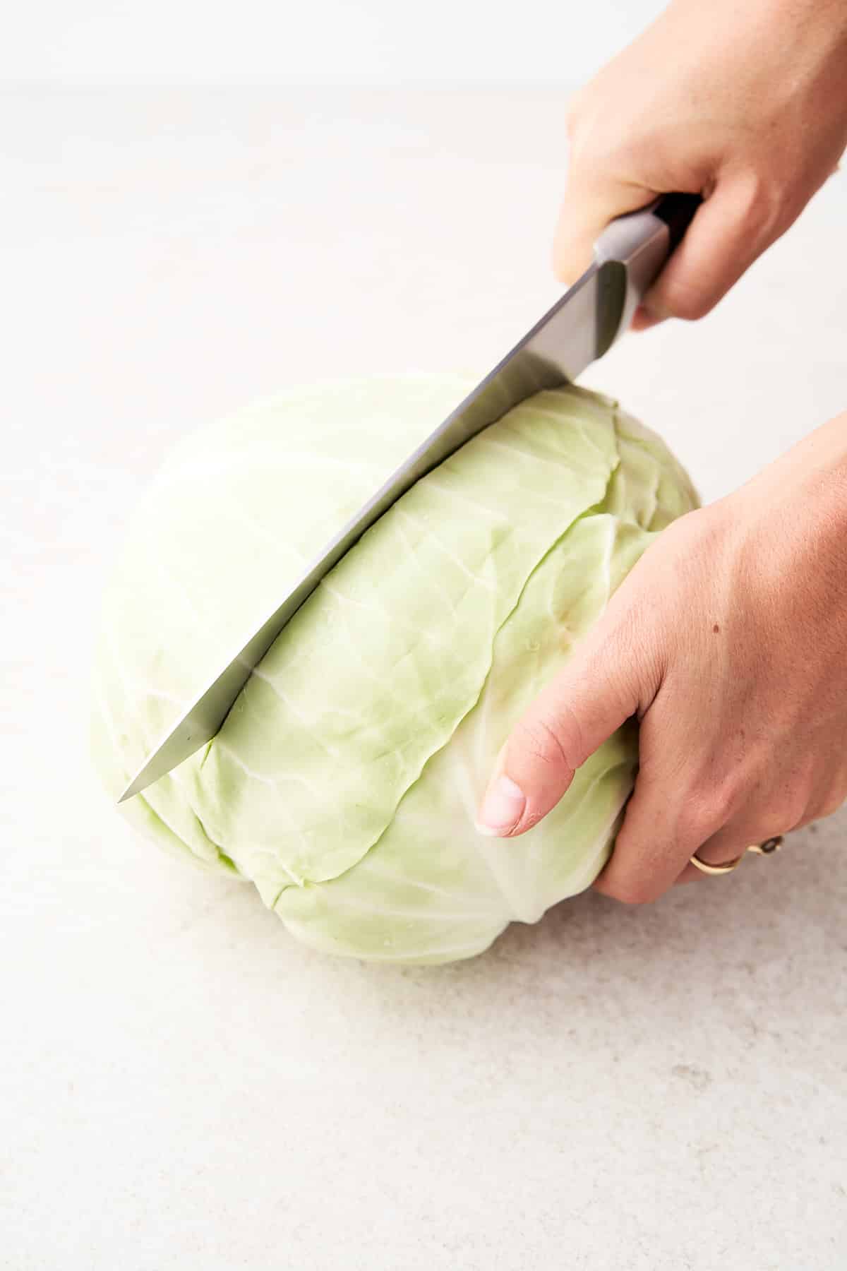 Cutting cabbage in half.