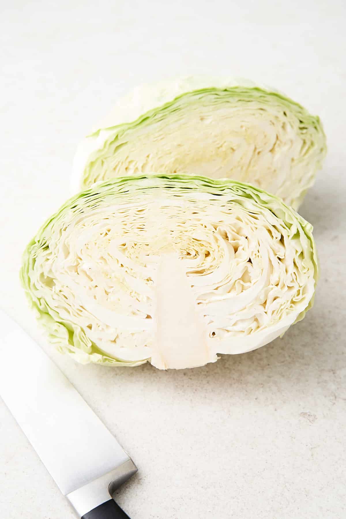 Cabbage cut in half on a table.
