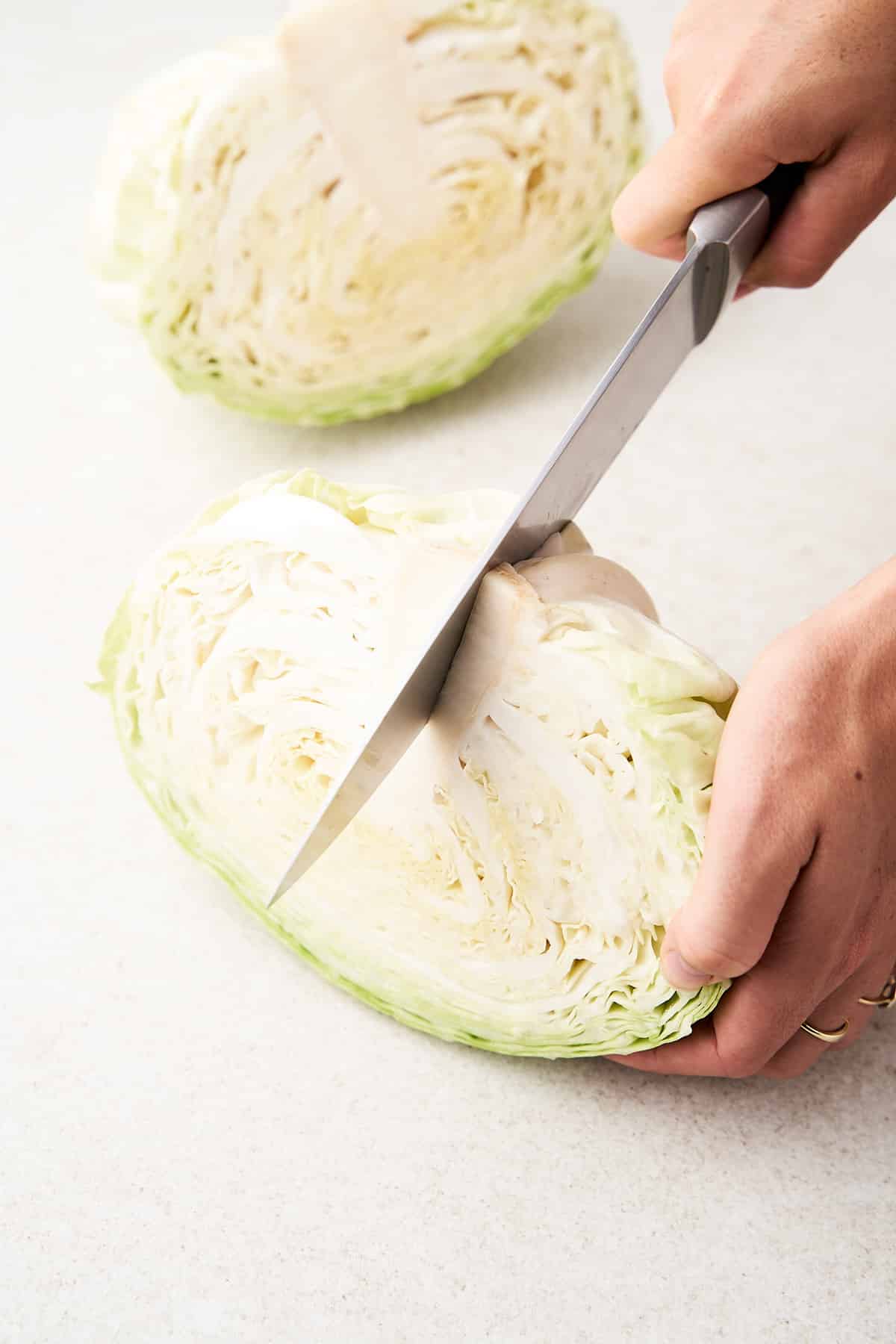 Cutting cabbage into quarters.