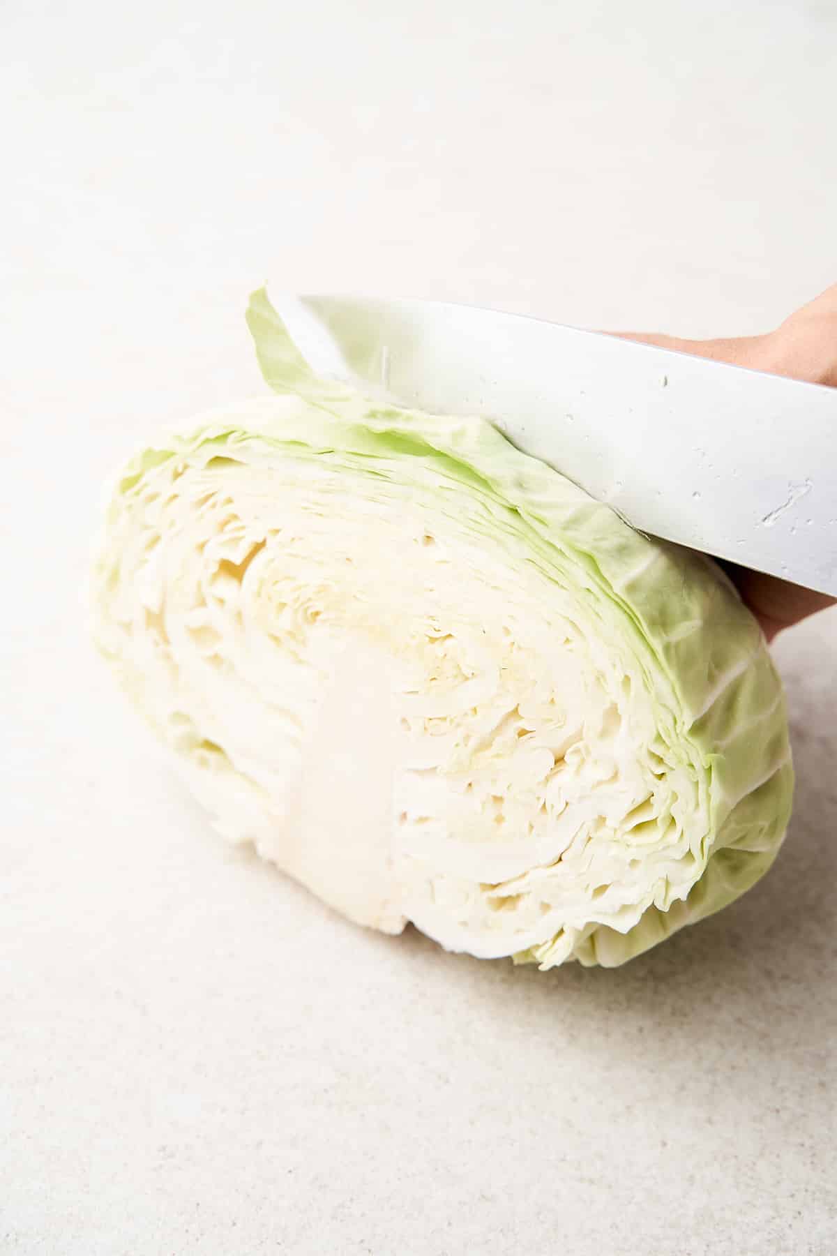 Cutting cabbage into steaks.