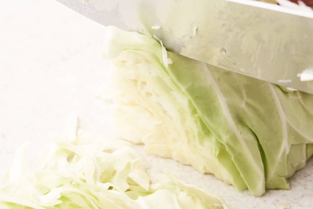 Cutting cabbage into shreds.