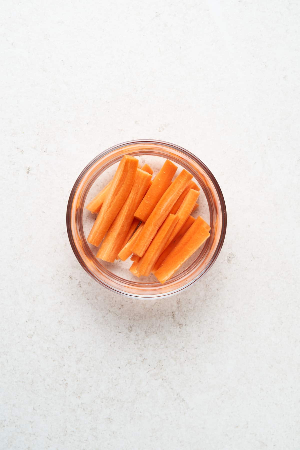 Carrot sticks in a container of water.