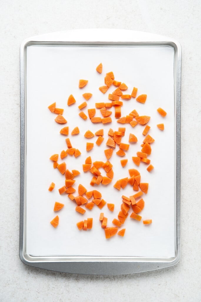 Blanched diced carrots on a baking sheet.