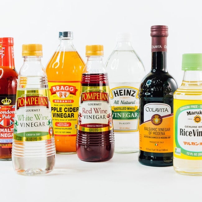 Many types of vinegar on a white background.