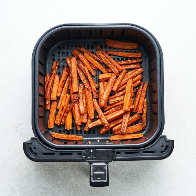 Carrot sticks in an air fryer.