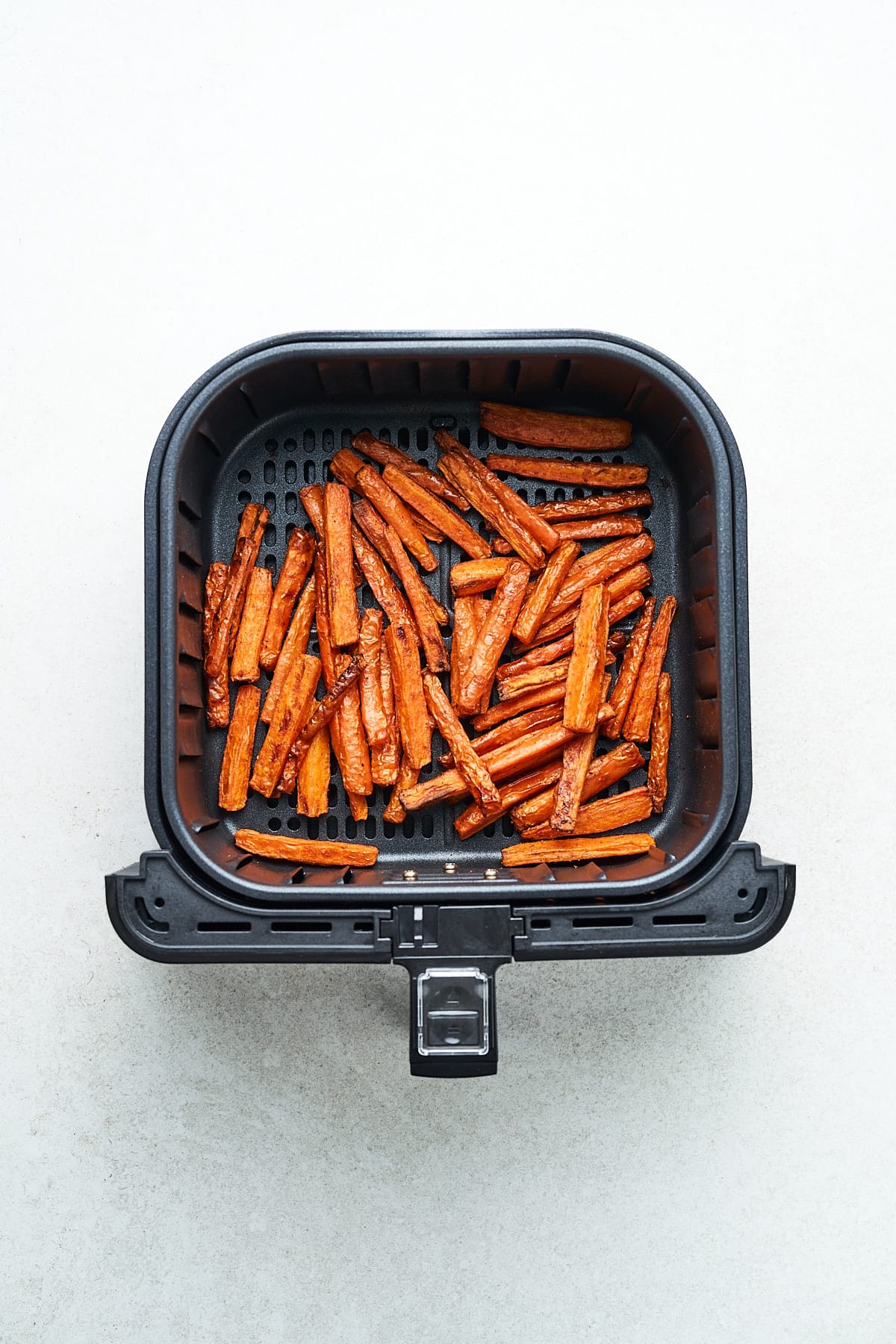 Carrot sticks in an air fryer.