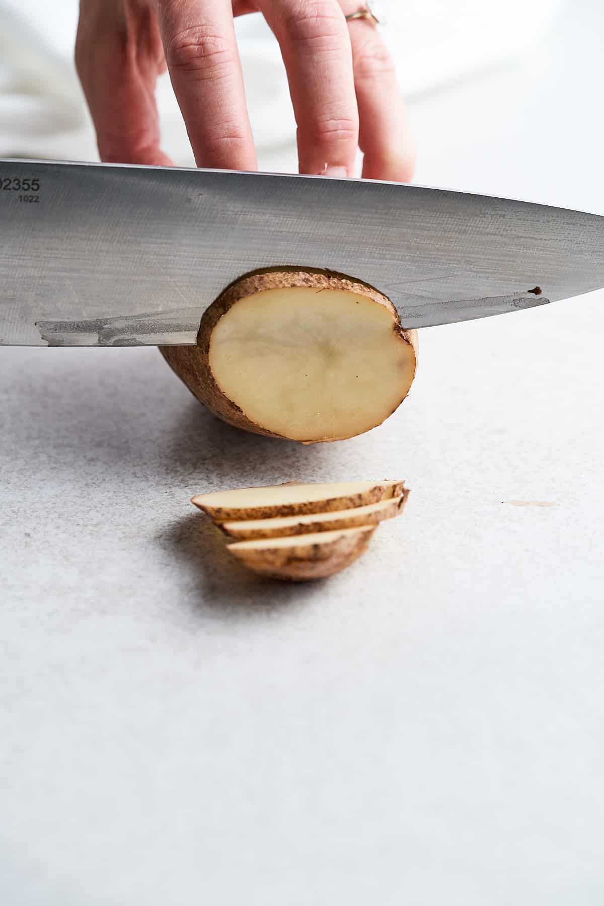 Slicing a potato into chips.