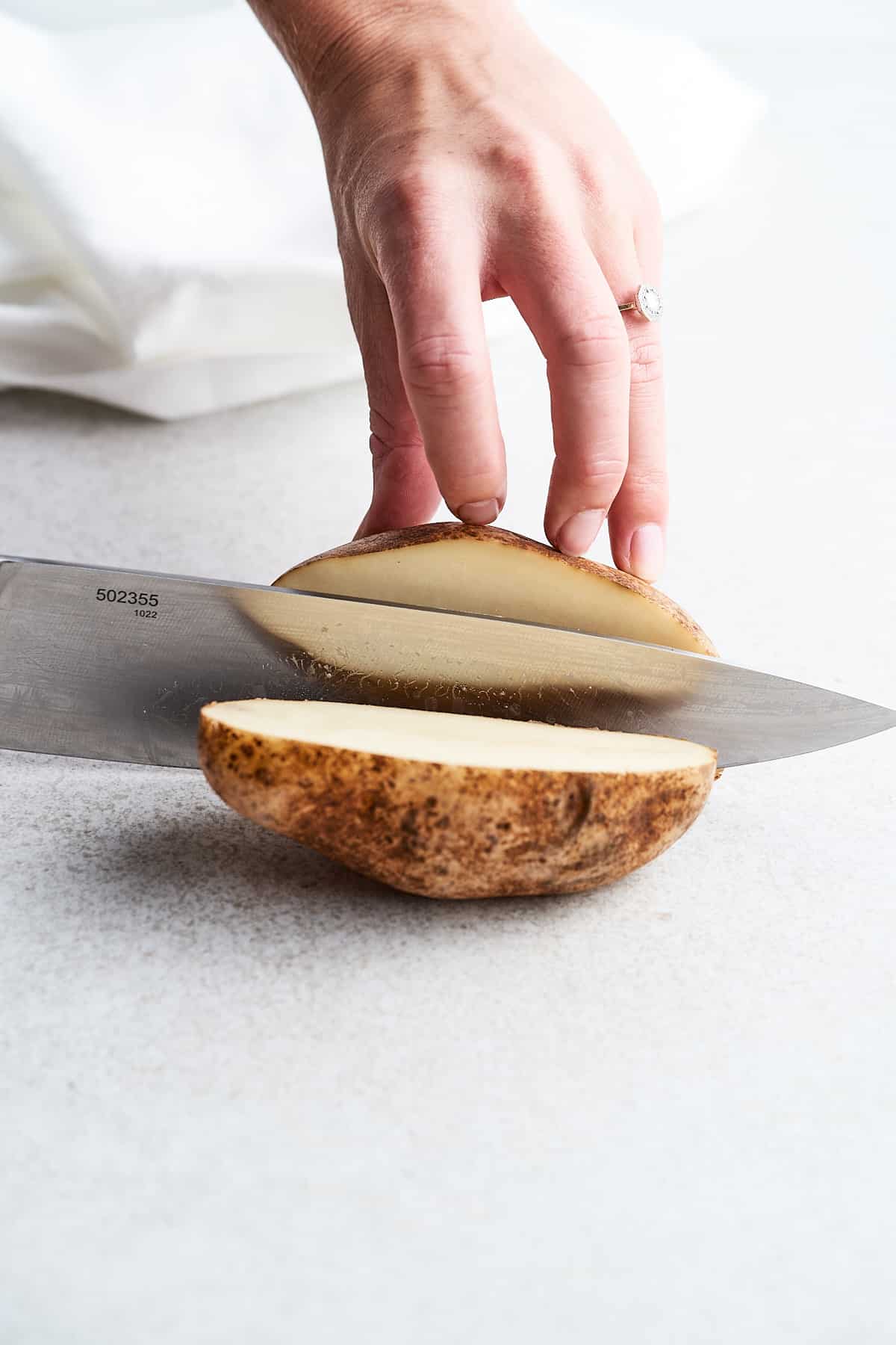 Cutting a potato in half.